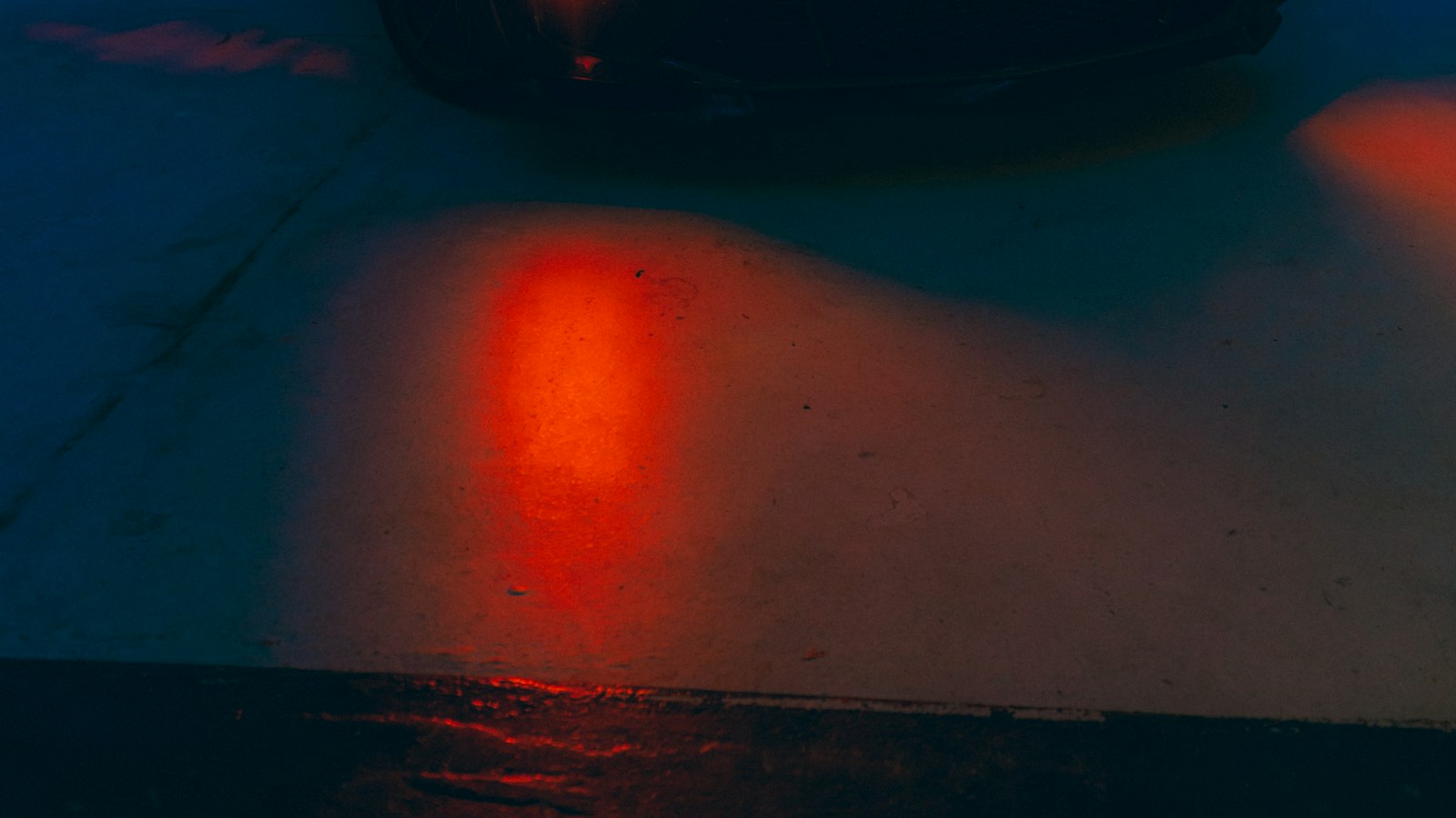 A car lit dramatically in a darkened studio.